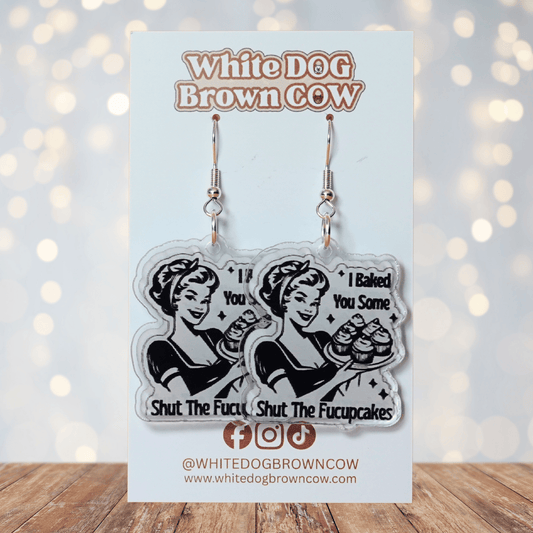 Retro style novelty dangle earrings with a vintage woman holding cupcakes and the phrase “I baked you some shut the fucupcakes”