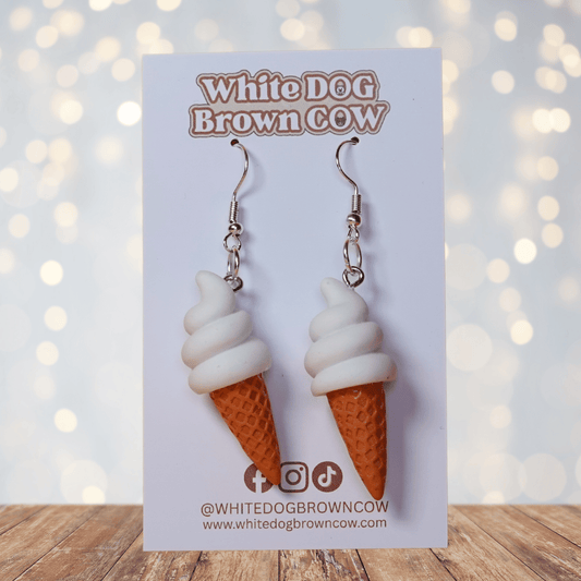 Cute dangle earrings shaped like soft serve vanilla ice cream in waffle cones.
