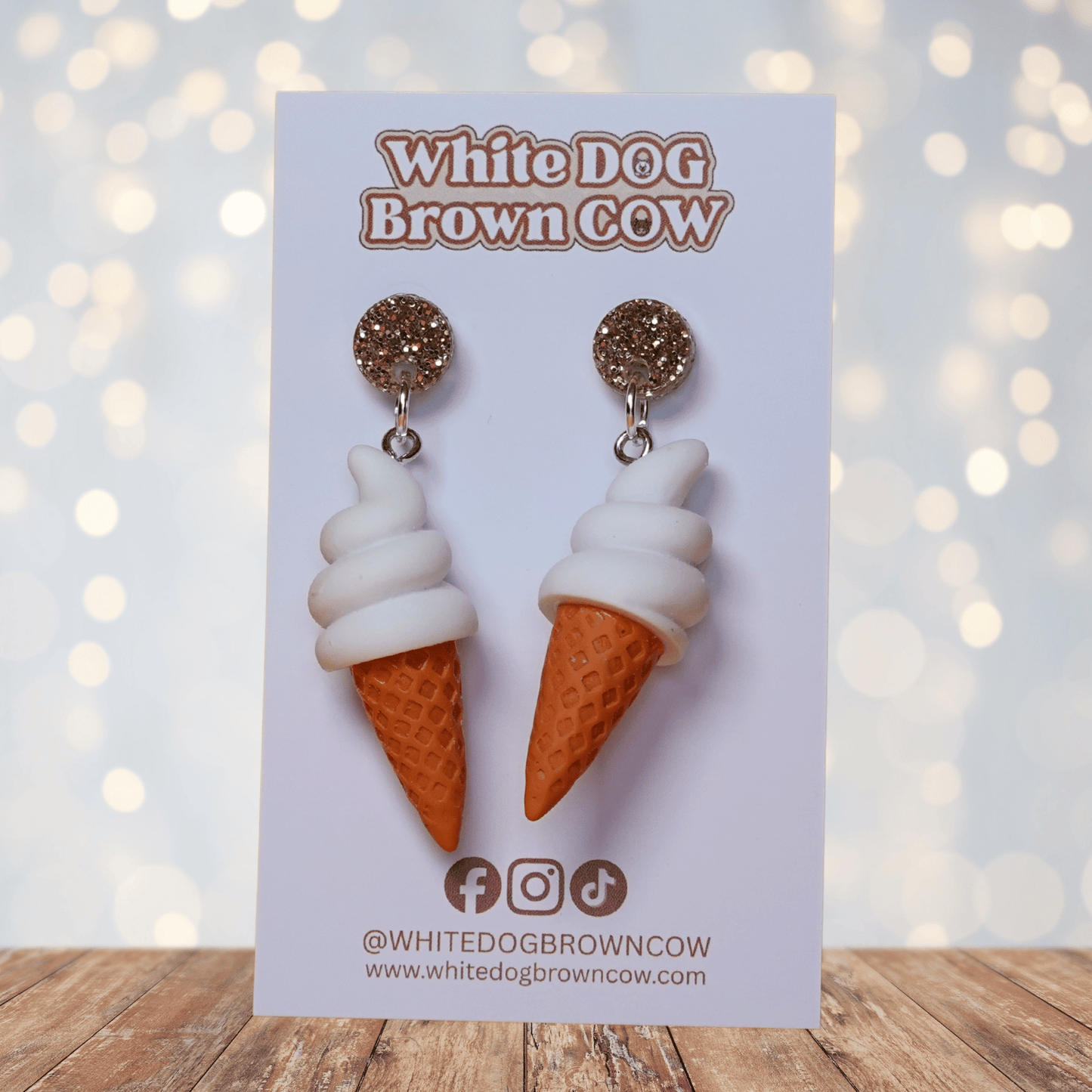 Cute dangle earrings shaped like soft serve vanilla ice cream in waffle cones.