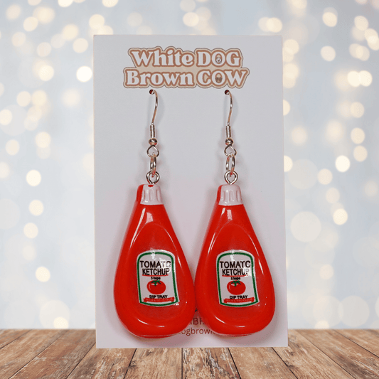 Red tomato ketchup bottle shaped dangle earrings with white cap and silver hooks.