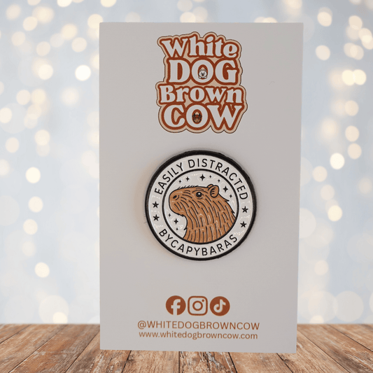 Cute enamel pin with capybara illustration and text “easily distracted by capybaras,” funny animal novelty pin